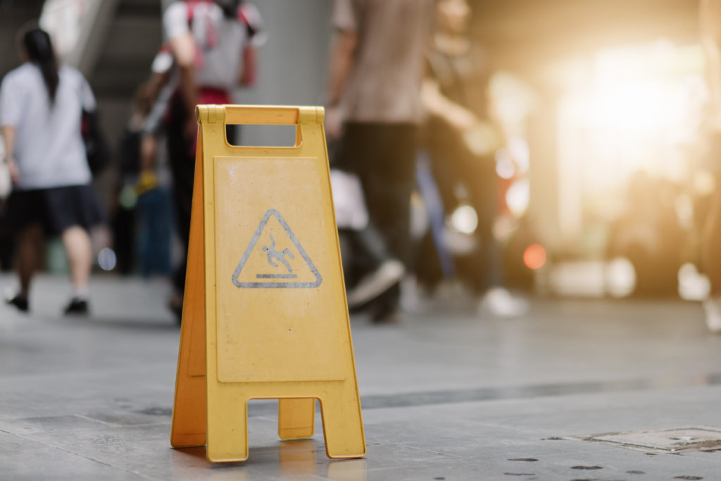 Sign showing warning of caution wet floor whitin airport.